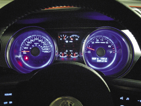 The deep-set analogue gauges harken back to Mustang instrument clusters of old.